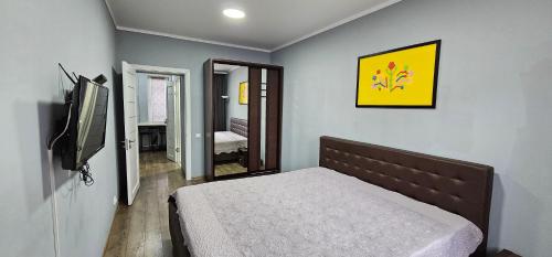 1 dormitorio con 1 cama y TV de pantalla plana en Central Park Apartment, en Chişinău