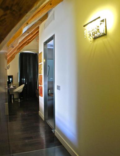 a hallway with a door to a room with a table at Hotel Sant Roc in Solsona
