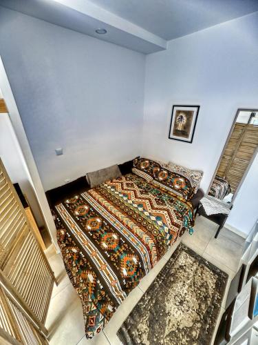 a bedroom with a bed with a colorful blanket at Olympian Heights in Olympia