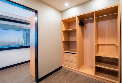 a walk in closet with a large mirror at Hyatt Regency Galleria Residence Dubai in Dubai