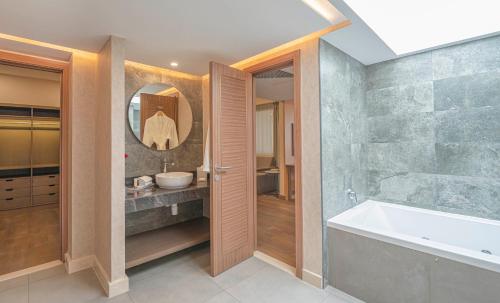 a bathroom with a bath tub and a sink at Hyatt Regency Galleria Residence Dubai in Dubai