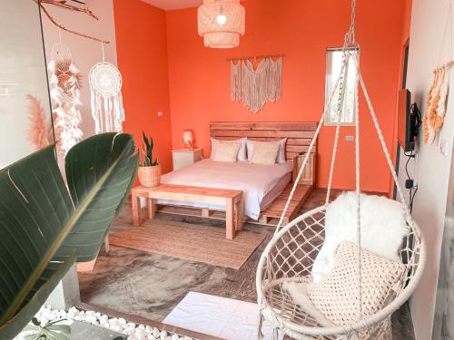 a bedroom with a swinging bed and a chair at Third Sister B&B in Xiaoliuqiu