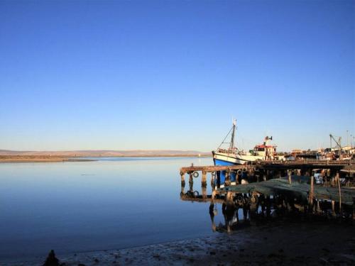 a boat is docked at a dock in the water at Fishermansrest in Velddrif