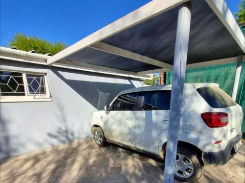 a white car is parked under a cover at Karoo Nest - Calitzdorp in Calitzdorp