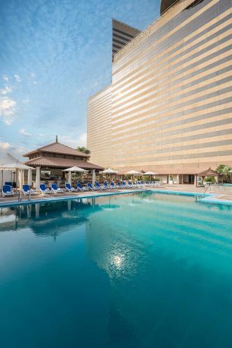 a large swimming pool in front of a hotel at Hyatt Regency Galleria Residence Dubai in Dubai
