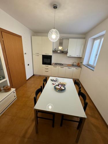a kitchen with a table and chairs in a room at Villa Bianca in Varenna