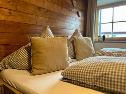 two beds with pillows on them in a bedroom at Haus Tirol Ehrwald in Ehrwald