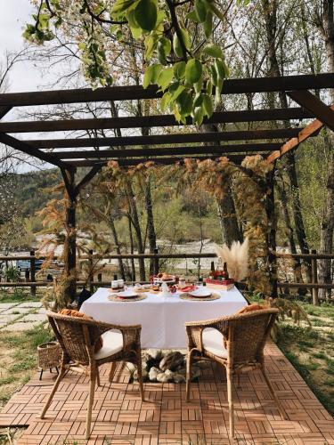 a dinner table under a pergola on a patio at Peker House in Bosmenso Superiore