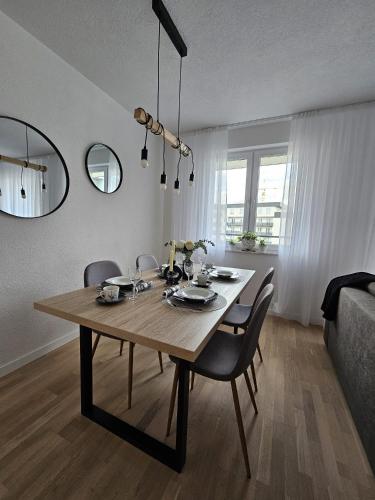 a dining room table and chairs in a living room at Apartman 33 in Kiseljak
