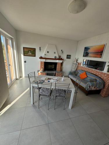 a living room with a table and chairs and a couch at Villa Bianca in Varenna