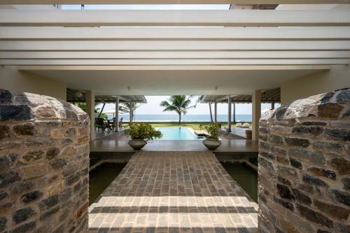 an external view of a house with a stone wall at Nil Ralla in Talpe