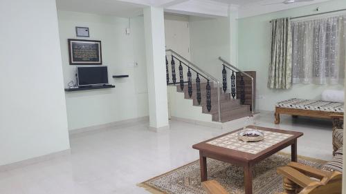 a living room with a couch and a table at Vazeer Residancy in Hyderabad