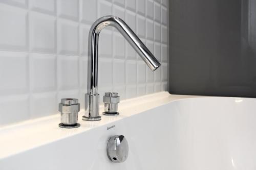 a kitchen sink with a chrome faucet at CHECK inn Taichung Liming in Taichung