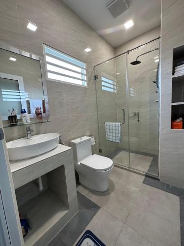 a bathroom with a toilet and a sink and a shower at Tiny House PT82 Kg Gumut Tambahan in Kalumpang
