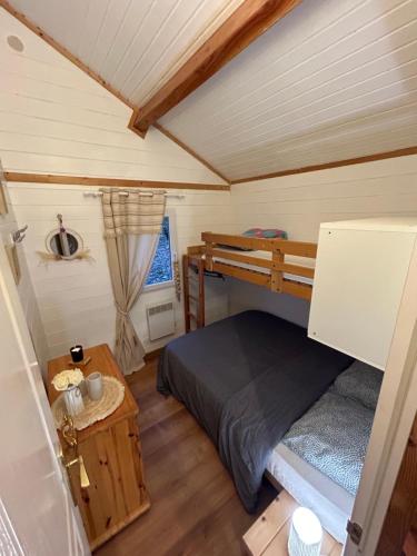 Cette petite chambre comprend des lits superposés et une table. dans l'établissement En toute quiétude, à Lissac-sur-Couze