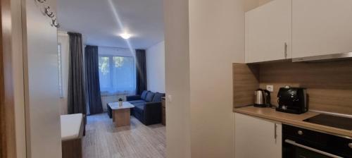 een kamer met een keuken en een woonkamer bij Borovets gardens Studios A11&A12 in Borovets