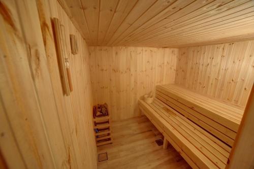 a wooden sauna with a bench in a room at Alena Boutique Hotel in Aqaba