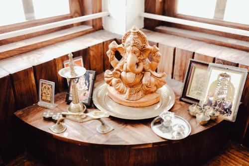 a table with a statue of an elephant on it at Ananda Holiday Home in Ambalavayal