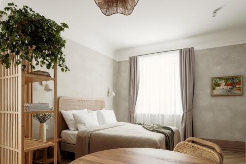 a bedroom with two beds and a window at Spīdalas nams in Cēsis