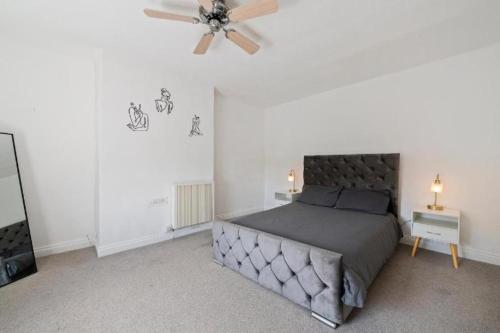 a bedroom with a bed and a ceiling fan at Tranquil Retreat in Heart of Somerset Countryside in Highbridge