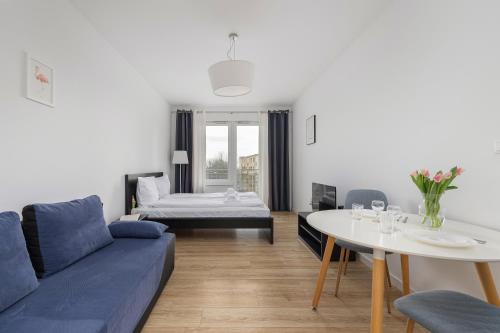 ein Wohnzimmer mit einem Sofa und einem Tisch in der Unterkunft Potulicka Comfort Studio in Stettin