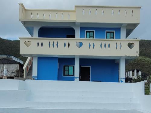 a blue house with hearts on the balcony at 鄉間小路 in Lanyu