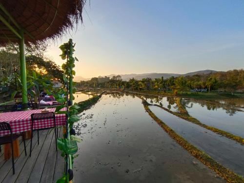 a view of a river with a table and chairs at Glamping Laos in Luang Prabang