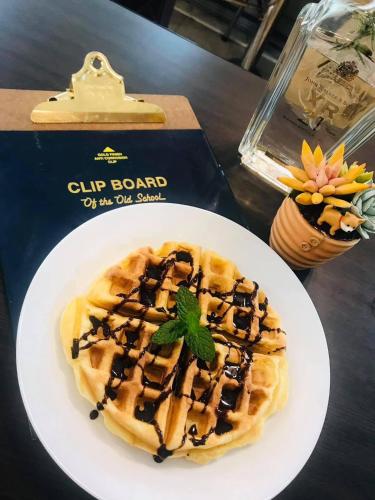 a waffle on a white plate on a table at Shi Bi Hotel in Gukeng