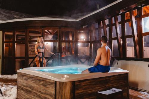 a man and a woman in a hot tub at Hotel Bankov Košice in Košice