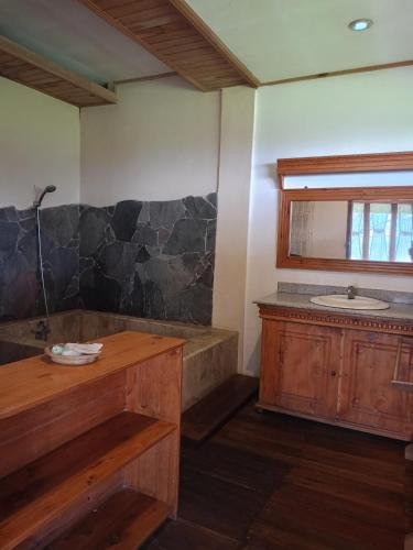 a bathroom with a tub and a sink at Sari Papandayan Resort Syariah in Garut