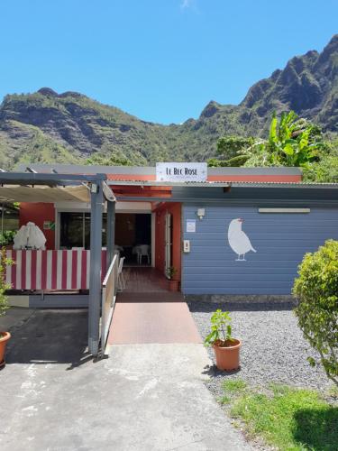 a building with a door with a chicken sign on it at Auberge du Cap in Cilaos