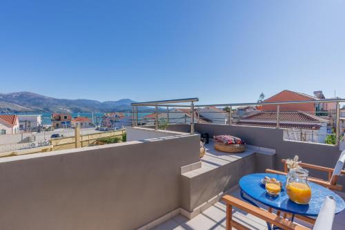 a balcony with two tables and a view of the ocean at Orizzonte in Lixouri