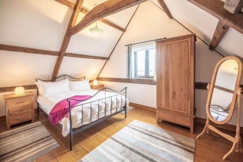 a bedroom with a bed and a window at South Barn, Nr Southwold in Southwold