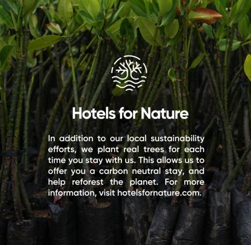 a picture of a bunch of plants with a sign at First Hotel Millennium in Oslo