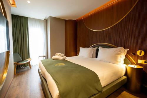 a hotel room with a bed with a teddy bear on it at Kate Hotel Special Class & SPA in Istanbul
