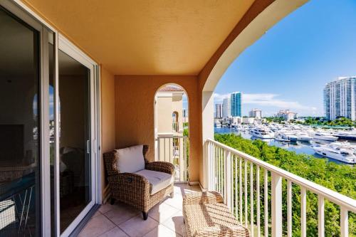 a balcony with a chair and a view of a harbor at Uhost AI - 3BR Condo - Stunning Water Views in Miami