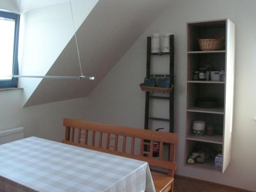 a room with a bed and a book shelf at Ferienwohnung Rhönbauer Altengronau in Sinntal