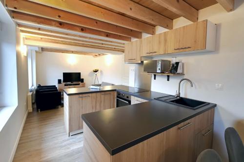 une cuisine avec un évier et un plan de travail dans l'établissement Le Grenier - Domaine de la Mauselaine, à Gérardmer