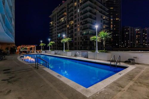 a swimming pool at night with a building at Bnb Hyperion - Ocean View - 3BR Condo w Pool & GYM in Miami