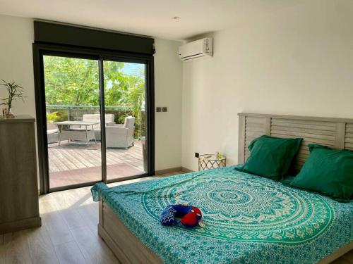 a bedroom with a bed with a stuffed animal on it at Kaz Ajeya in Les Avirons