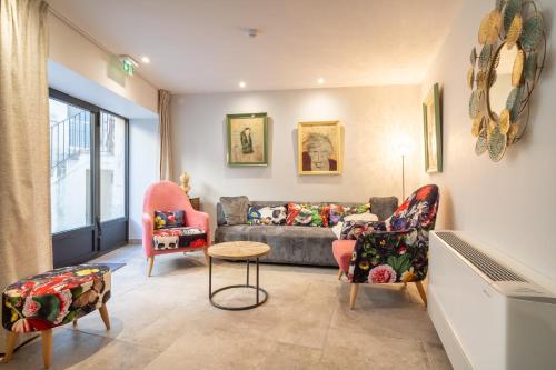 a living room with a couch and chairs at La Barule in Charols