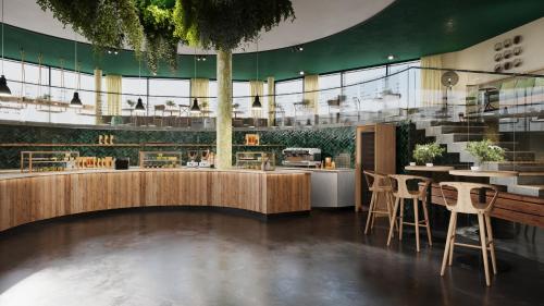 un restaurante con mesas y sillas en un edificio en REVERB by Hard Rock Hamburg en Hamburgo