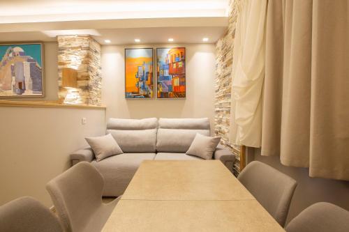 a living room with a table and a couch at Mariet Athens Boutique Spa in Athens