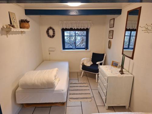 a living room with a couch and a chair at Rødsten Gæstegård in Ulfborg