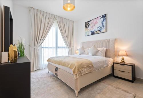 a bedroom with a bed and a large window at EasyGo - Lamtara 1 Burj Al Arab 2 Bedroom & Maid in Dubai