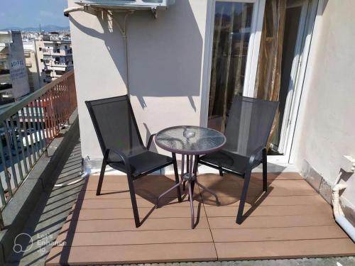 a patio with two chairs and a table on a balcony at Elegant Studio in the center of city. in Thessaloniki