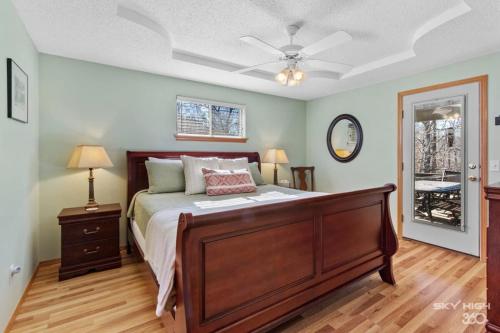 a bedroom with a bed and a ceiling fan at Cozy Quiet Retreat In The Woods in Bella Vista