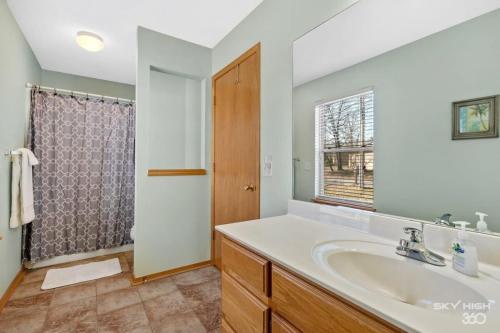 a bathroom with a sink and a shower at Cozy Quiet Retreat In The Woods in Bella Vista
