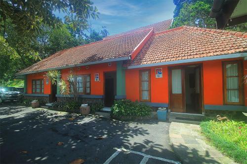 a small orange house with a red roof at Hotel Villa Rawa Pening Pratama by Aparian in Bandungan