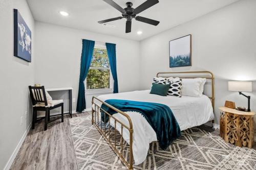 a bedroom with a bed and a ceiling fan at NEW! Boho Bungalow in Bella Vista